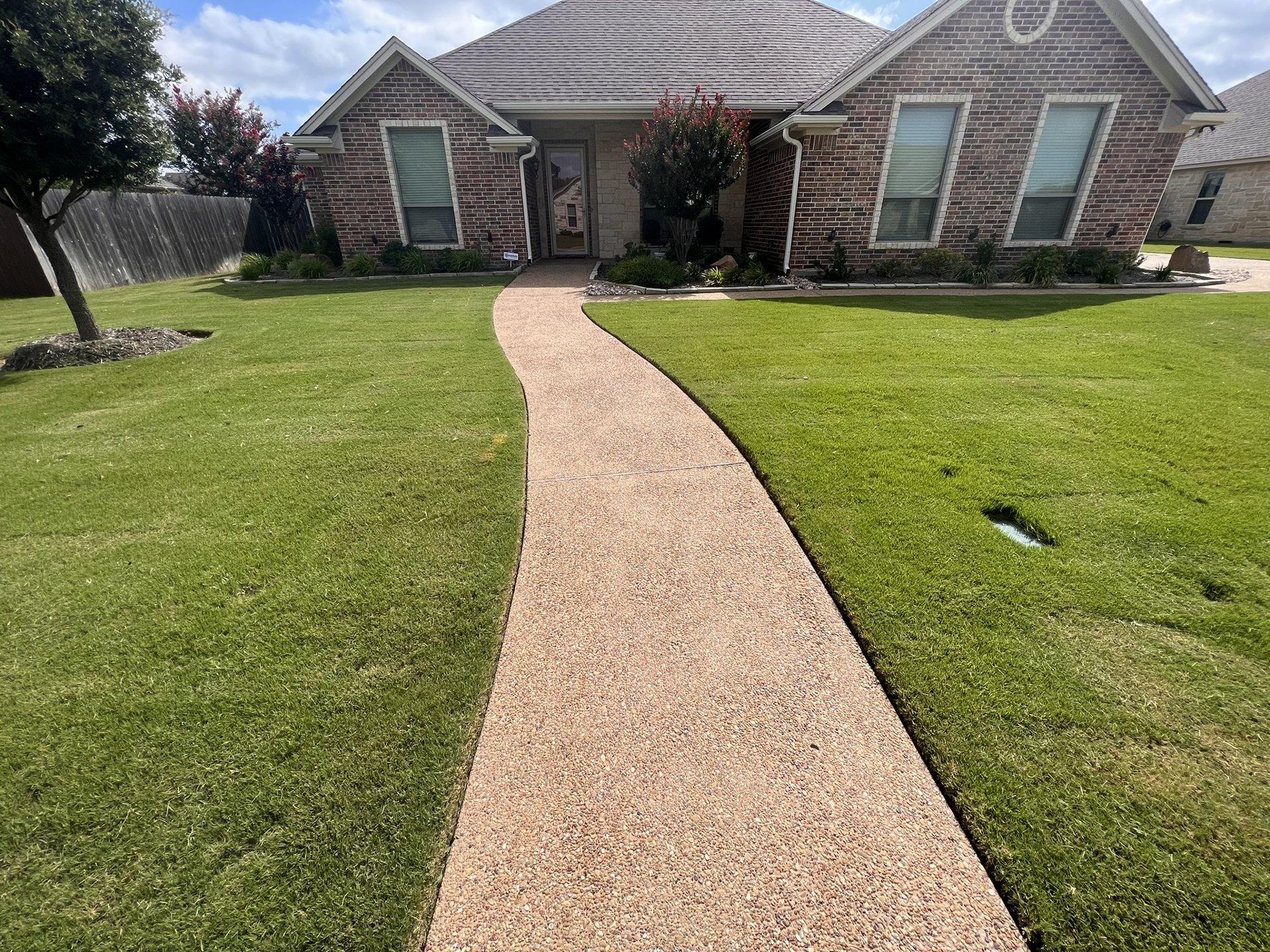 Front yard sidewalk landscape installation